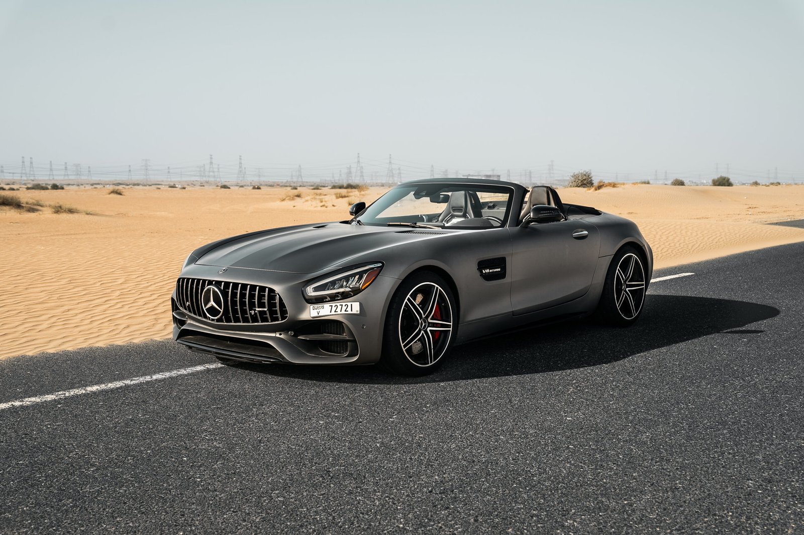 Mercedes-AMG GTC convertible car on a desert road in Dubai